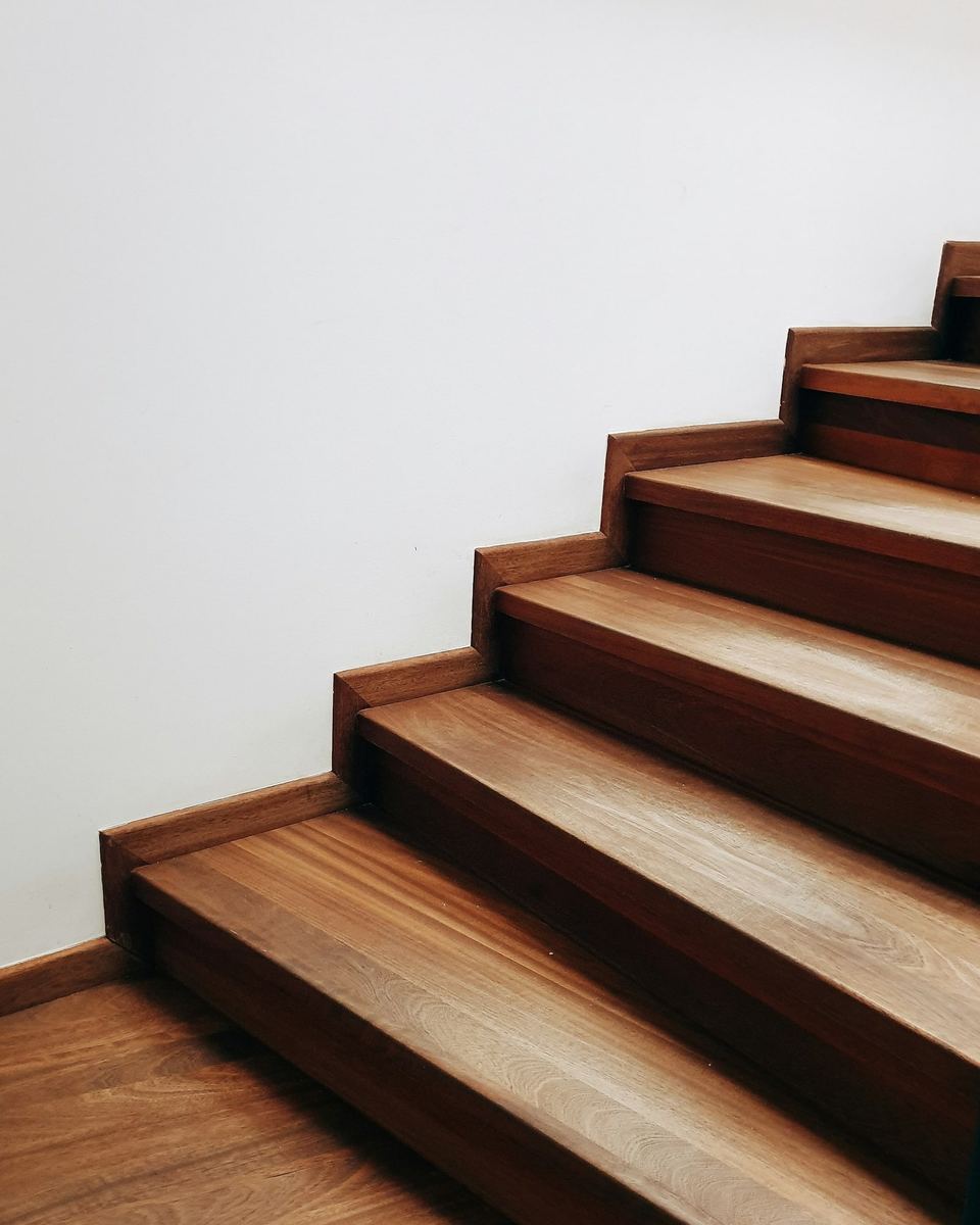 Oak stair treads rising against a white wall