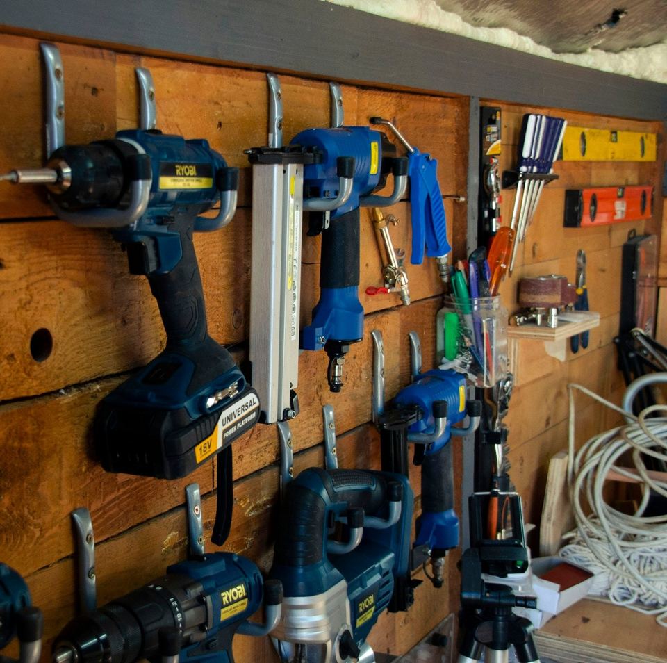 Power tools hung on a timber workshop wall